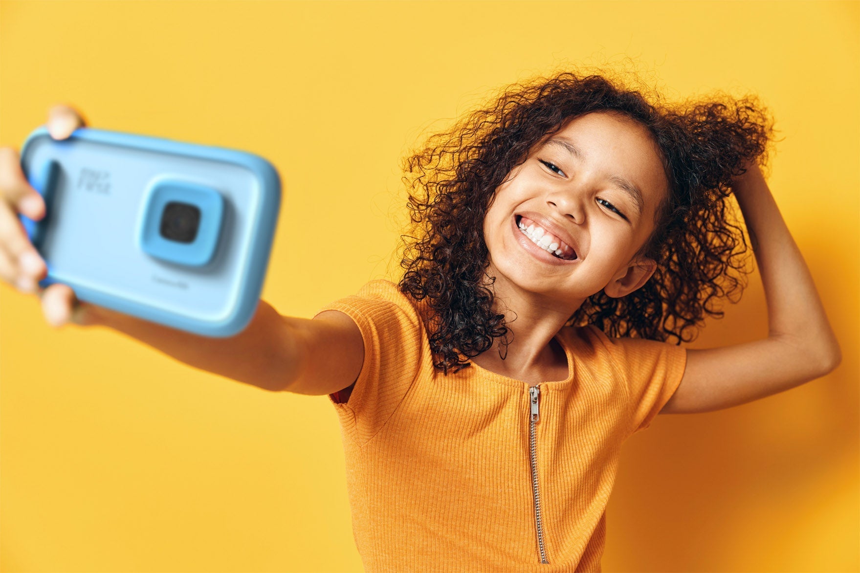Girl taking a selfie with myFirst Camera 50 Blue