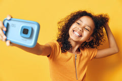 Girl taking a selfie with myFirst Camera 50 Blue
